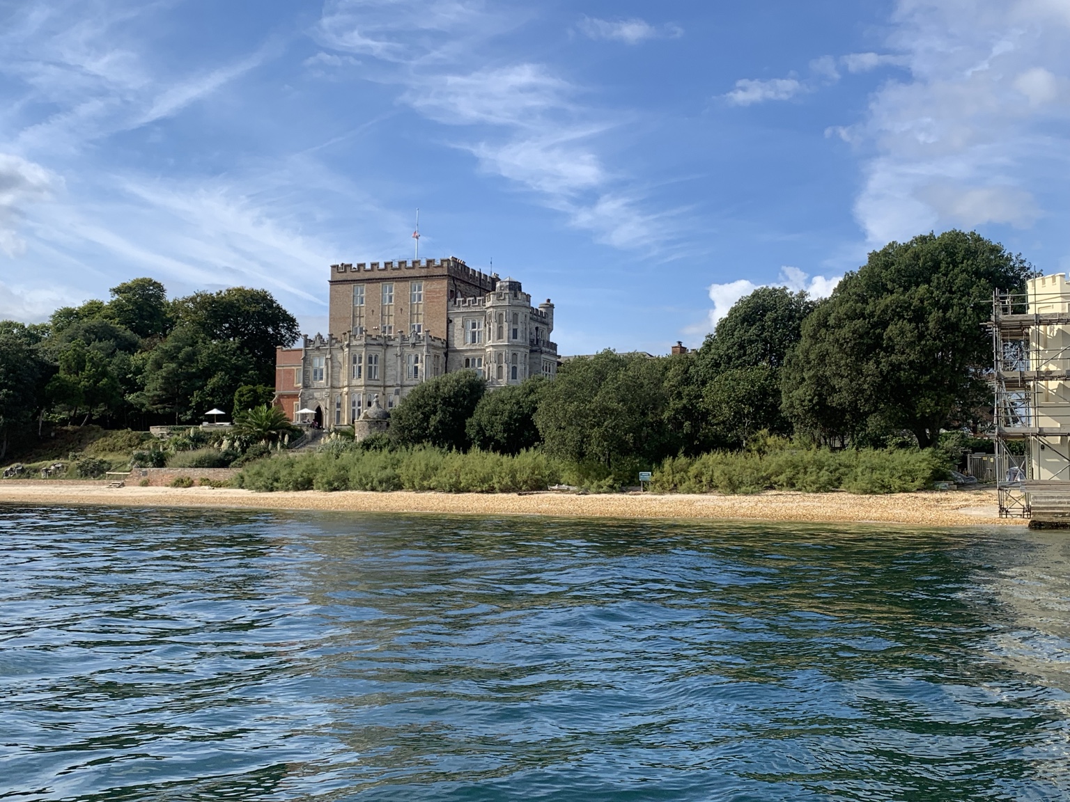 Brownsea Castle and the wooded shoreline of Brownsea Island seen from the water