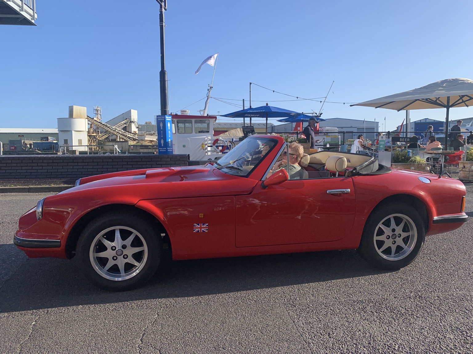 Red convertible on Poole Quay on a summer evening
