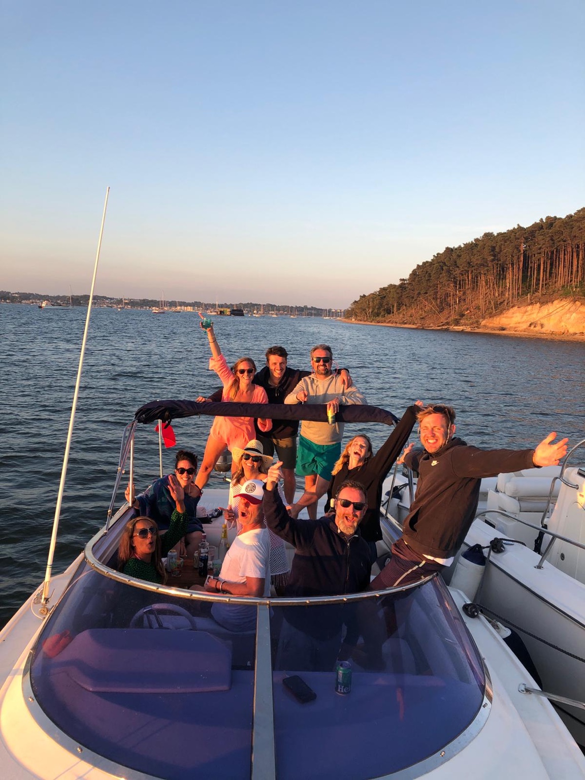 Friends aboard a boat in evening sunshine