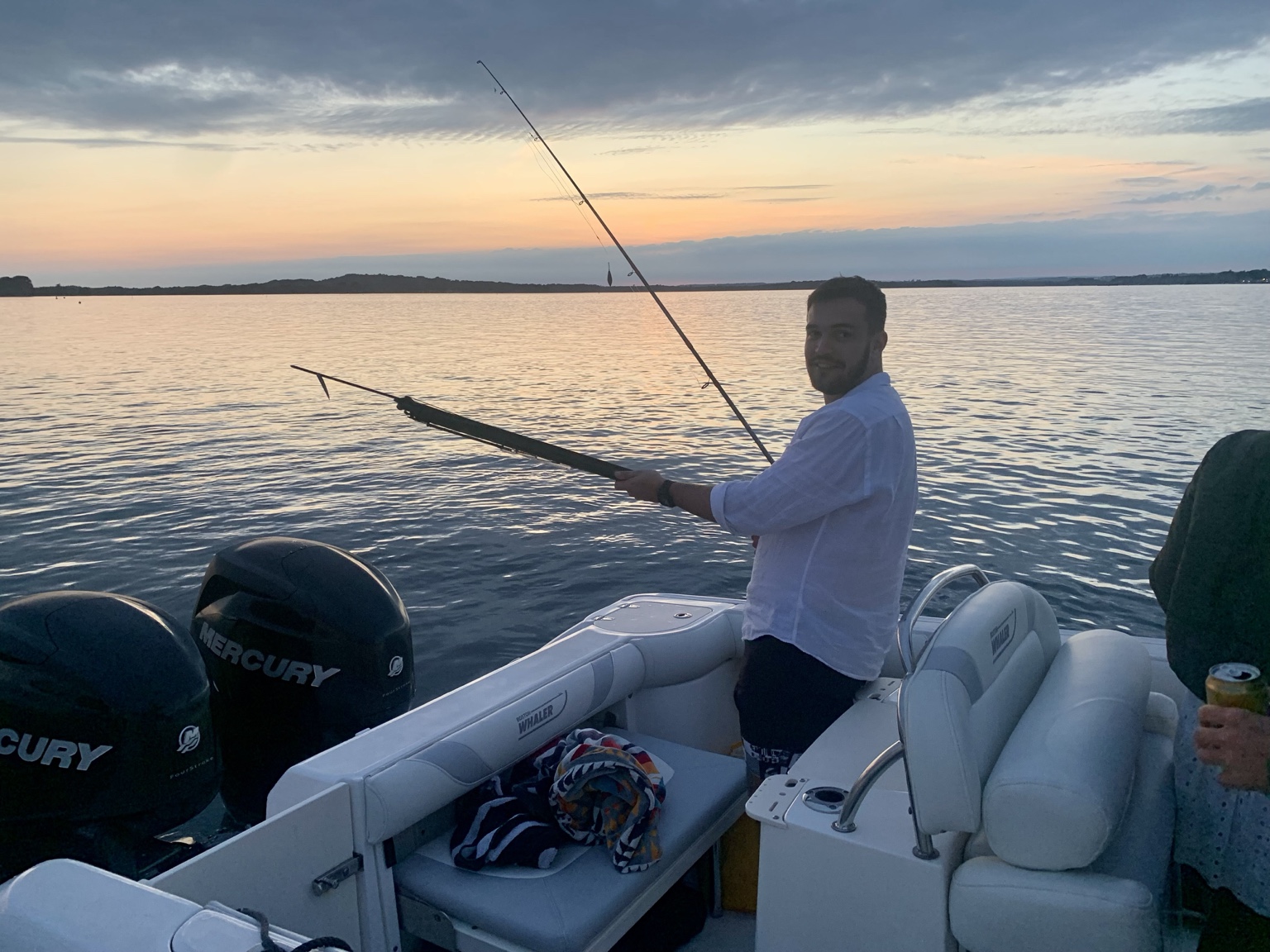 Fishing from a boat at sunset