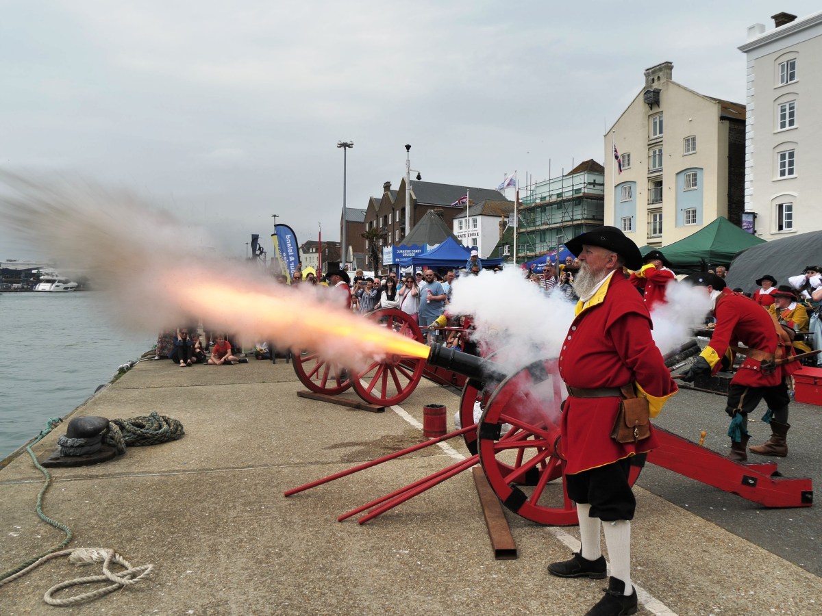 Pirates firing a cannon during Harry Paye Day on Poole Quay