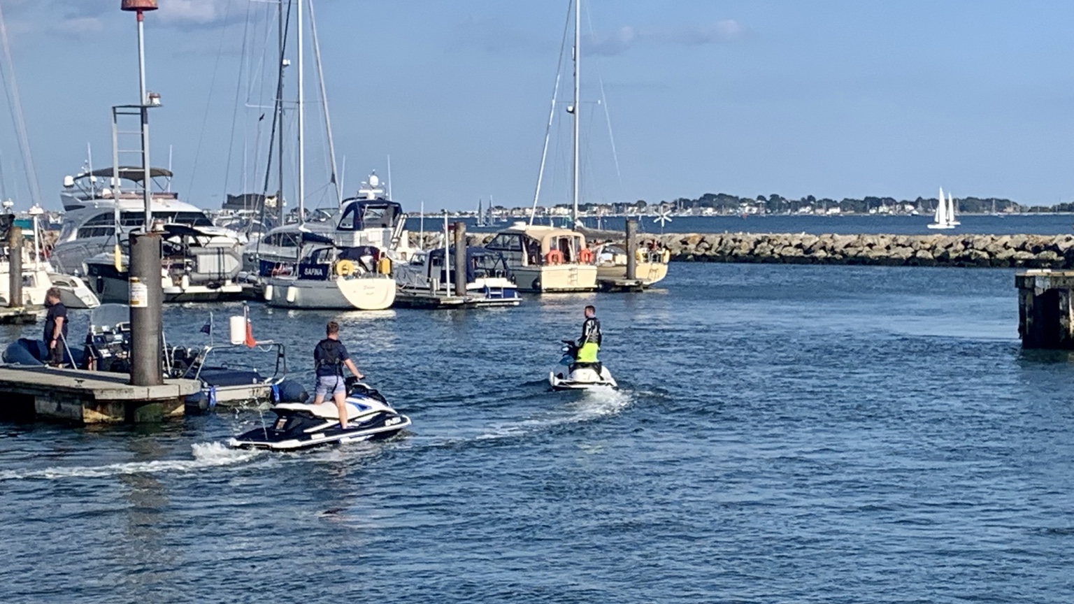 Jet skis departing a marina in Poole Harbour