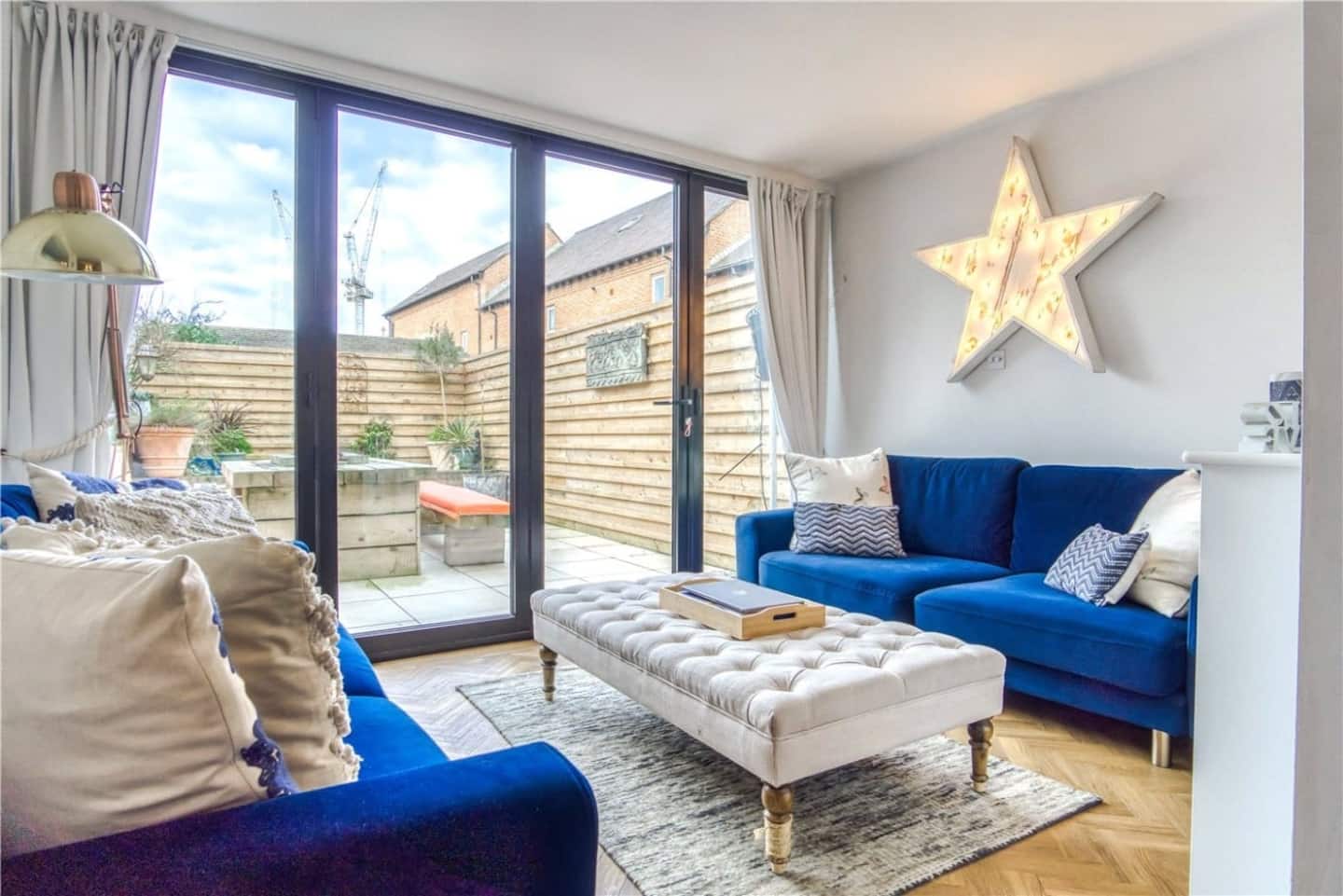 Blue sofas in the living room opening to the courtyard