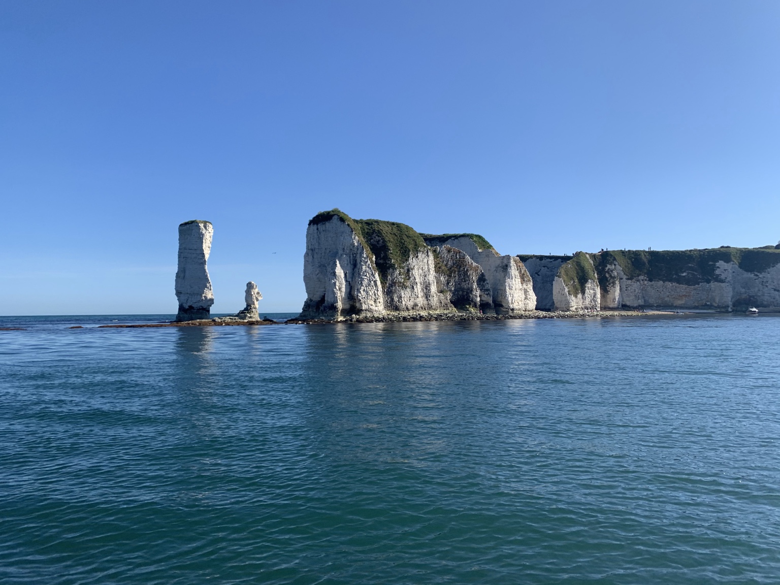 Old Harry Rocks chalk cliffs and arches seen from a boat