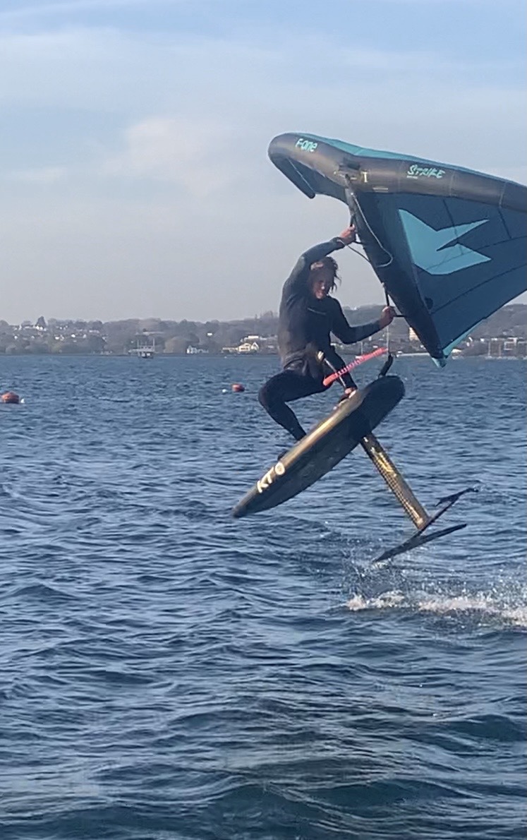 Wing foiling above the water
